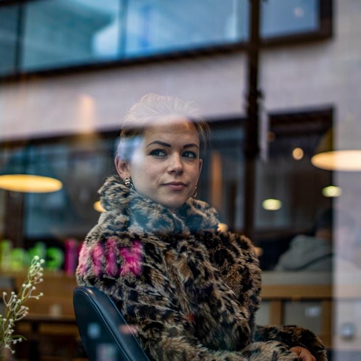 Kaveri Mehta, Lead Design Curator at BeaconLeafStudio, reviewing corporate floral arrangements